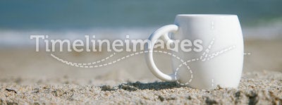 Espresso coffee in white cup with ocean waves