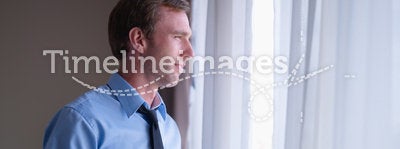 Businessman drinking coffee and looking outside