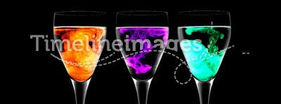 Three wine glasses with food coloring