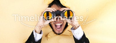 Shocked businessman with binoculars