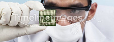 Scientist holding a computer microchip