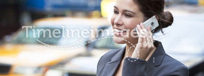 Young Woman Talking on Cell Phone by Yellow Taxi
