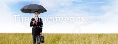 Businessman with umbrella shot outdoor