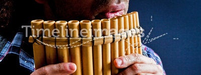 Panflute old played in his hand