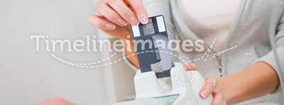 Sales person inserting card into scanner