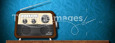 Retro radio on wood table with blue wallpaper