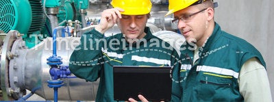 Industrial workers with notebook