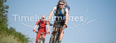 Two cyclists biking