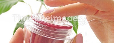 Hands with a cosmetic cream