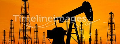 Silhouette oil rigs and pumps