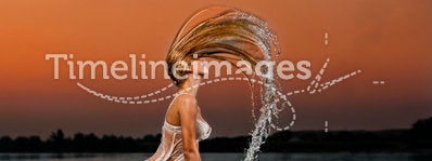 blonde woman in water at sunset