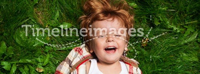 Adorable kid laughing on grass