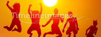Silhouettes of happy teenagers jumping high