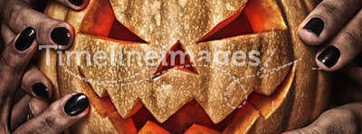 Evil pumpkin with glowing eyes that are holding