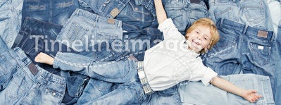 Happy child on jeans background. Denim fashion
