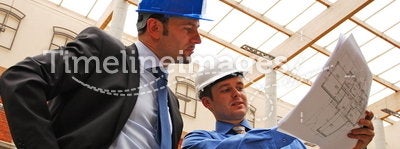 Businessmen Studying Blueprint