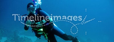 Diver with camera in deep