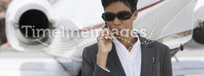 Confident Businesswoman Using Cellphone At Airfield
