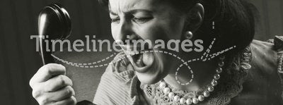Angry woman screaming at retro phone
