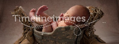 Newborn in Military Helmet