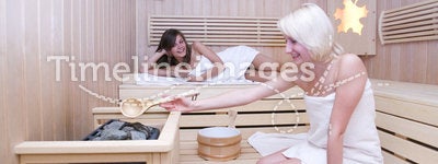 Blond and brunette women in sauna