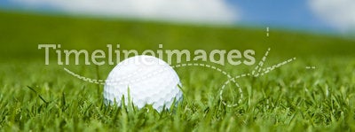 Golf ball on green fairway