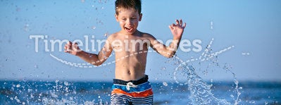 Cute little boy having fun at the beach
