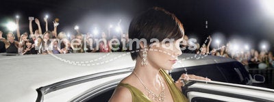 Woman Getting Out Of Limousine In Front Of Fans And Paparazzi