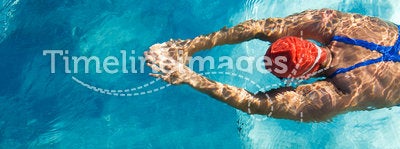 Diving. Athletic swimmer is diving in a swimming pool