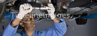 Auto mechanic under car
