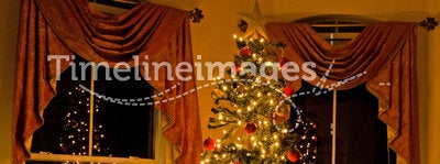 Lighted christmas tree in cozy home