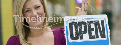 Pretty woman with open sign