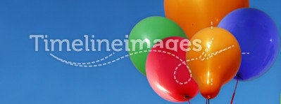 Balloons Floating in Blue Sky