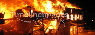 Firefighter fighting burning house