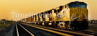 Train locomotive traveling through desert