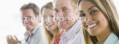 Group of four businesspeople applauding