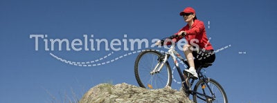 The woman on mountain bicycle