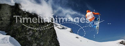 Snowboarder jumping from a cliff