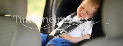 Boy in child car seat