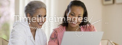 Mother and daughter sharing computer