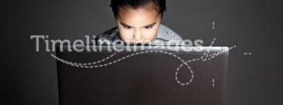 Little half-asian boy using a laptop
