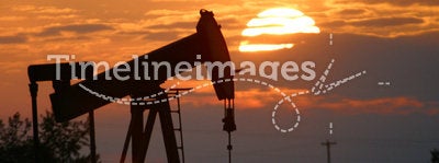Oil pump jack at sunset