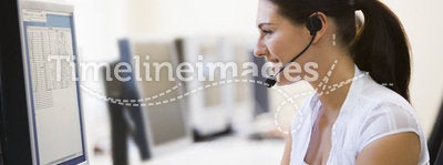 Woman wearing headset in computer room smiling
