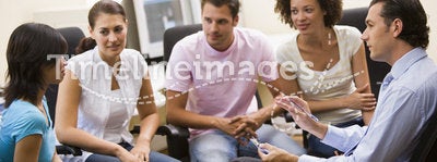 Man giving lecture to four people in computer room