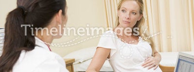 Doctor with laptop and pregnant woman