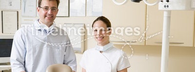Dentist and assistant in exam room