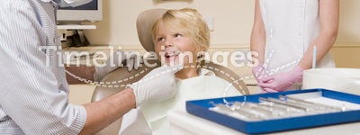 Dentist and assistant with young boy