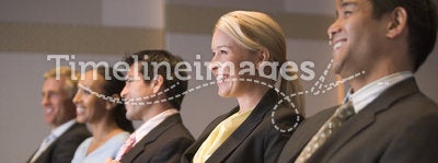 Five businesspeople smiling in presentation