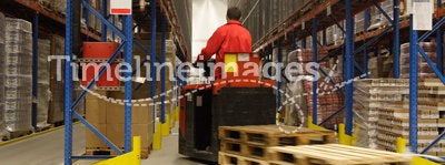 Forkift operator in factory warehouse