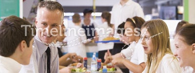 A teacher eating lunch with his students